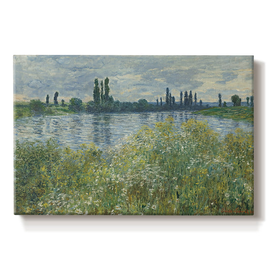 Canvas art print portraying a riverbank landscape with water, trees, and distant village buildings, set against a white background