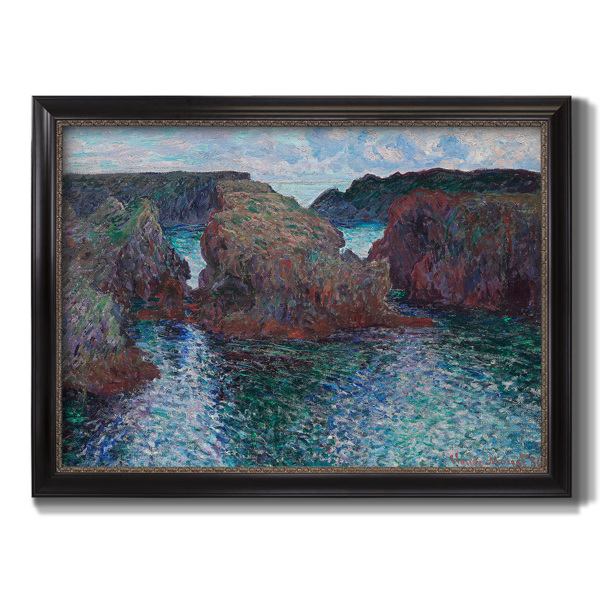 Impressionist rocky seascape by Claude Monet printed on canvas in an ornate black frame with gilded inner detail.