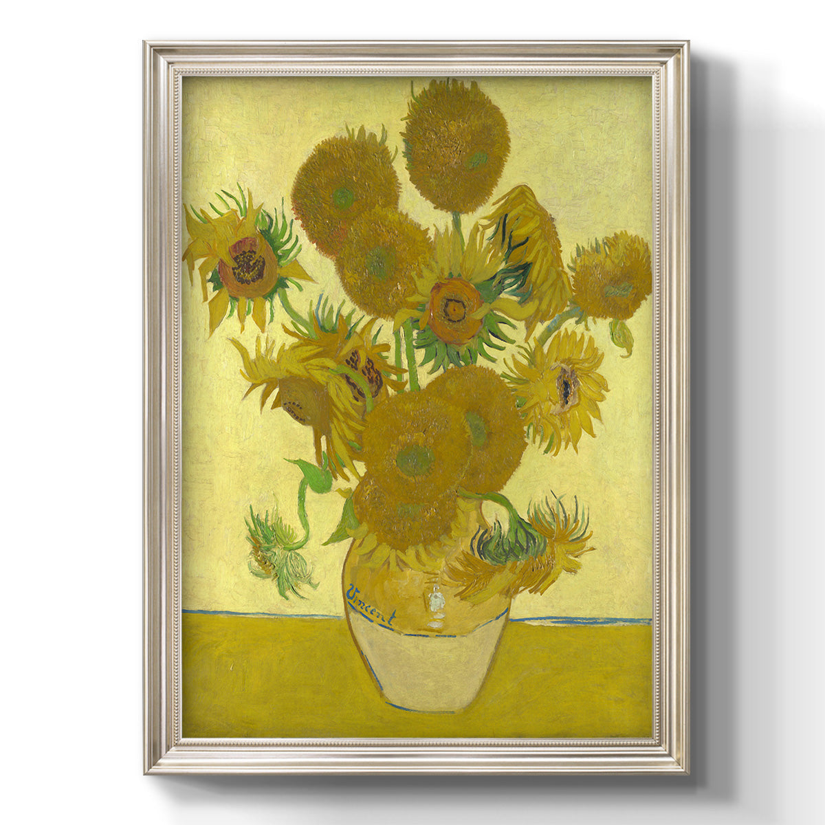 Impressionist sunflower still life painting by Vincent van Gogh printed on canvas in an ornate black frame with gilded inner detail with a vertical orientation.