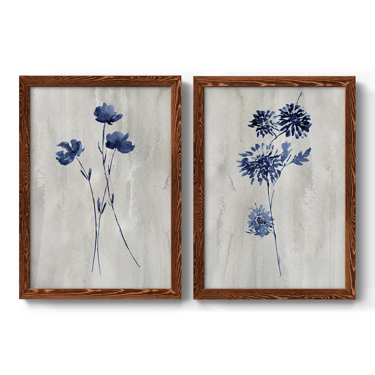 Set of two maple barnwood framed canvas prints featuring two rustic monochrome botanical paintings featuring blue wildflower stems on weathered neutral paper.
