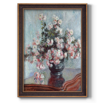 Impressionist chrysanthemum floral painting by Claude Monet printed on canvas in an ornate weathered white frame with a vertical orientation.