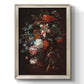 Classical floral still life painting by Jan van Huysum printed on canvas in an ornate black frame with gilded inner detail with a vertical orientation.