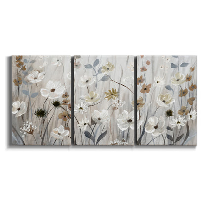 Three-panel canvas wall art featuring misty wildflower meadow landscape on white background.
