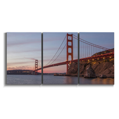 Three-panel canvas wall art featuring golden gate bridge spanning bay on white background.