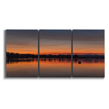 Three-panel canvas wall art featuring glowing sunset over water on white background.