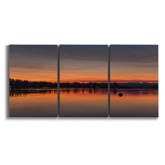 Three-panel canvas wall art featuring glowing sunset over water on white background.