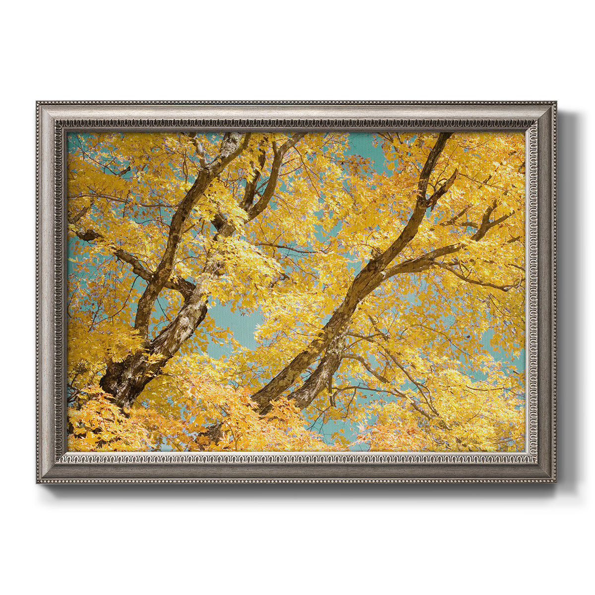 Vibrant yellow autumn leaves on branches printed on canvas in an ornate vintage silver frame.