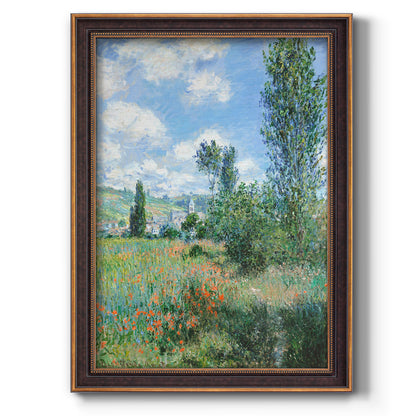 Impressionist pastoral landscape with poppy fields by Claude Monet printed on canvas in an ornate bronzed mahogany wood frame with a vertical orientation.