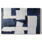 Abstract artwork featuring a contrast of navy blue and white shapes on canvas