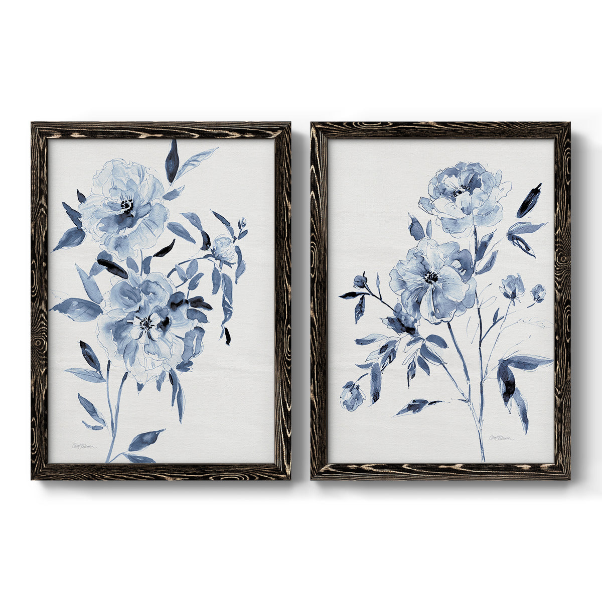 Set of two black barnwood framed canvas prints featuring two expressive watercolor botanical paintings featuring loose blue flowers and leafy branches.