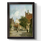 Rustic European street scene painting by Adriaan Eversen printed on canvas in an ornate black frame with gilded inner detail with a vertical orientation.