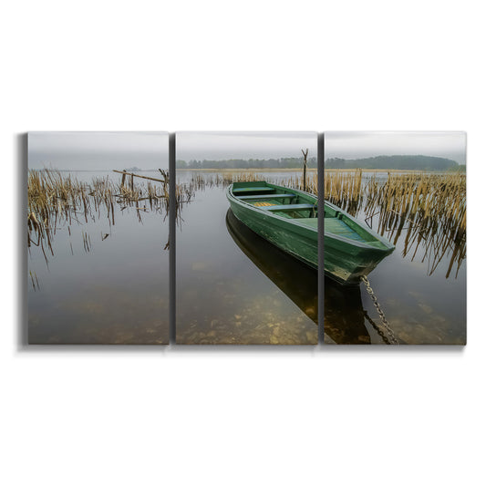 Three-panel canvas wall art featuring small green boat on water on white background.