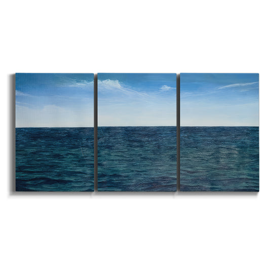 Three-panel canvas wall art featuring open water landscape with wide horizon on white background.