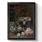 Early impressionist floral painting by Claude Monet printed on canvas in an ornate black frame with gilded inner detail with a vertical orientation.