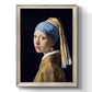 Iconic portrait of a girl wearing a pearl earring by Johannes Vermeer printed on canvas in an ornate black frame with gilded inner detail with a vertical orientation.