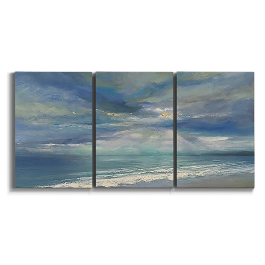 Three-panel canvas wall art featuring sunbeams breaking through coastal clouds on white background.
