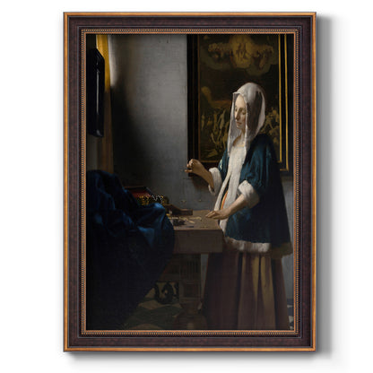 Quiet interior genre scene of a woman with scales by Johannes Vermeer printed on canvas in an ornate bronzed mahogany wood frame with a vertical orientation.