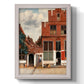 Realist city street scene by Johannes Vermeer printed on canvas in an ornate weathered white frame with a vertical orientation.