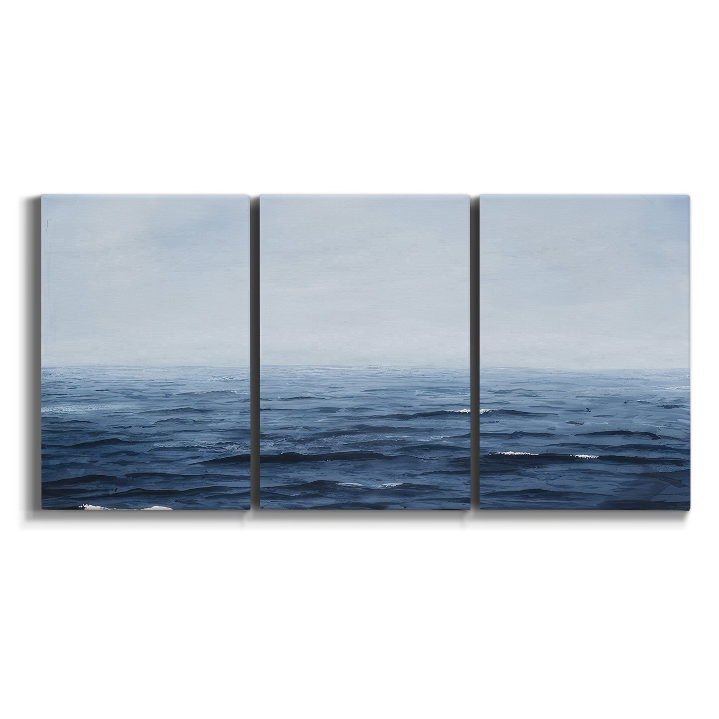 Three-panel canvas wall art featuring grayscale seascape with horizon on white background.