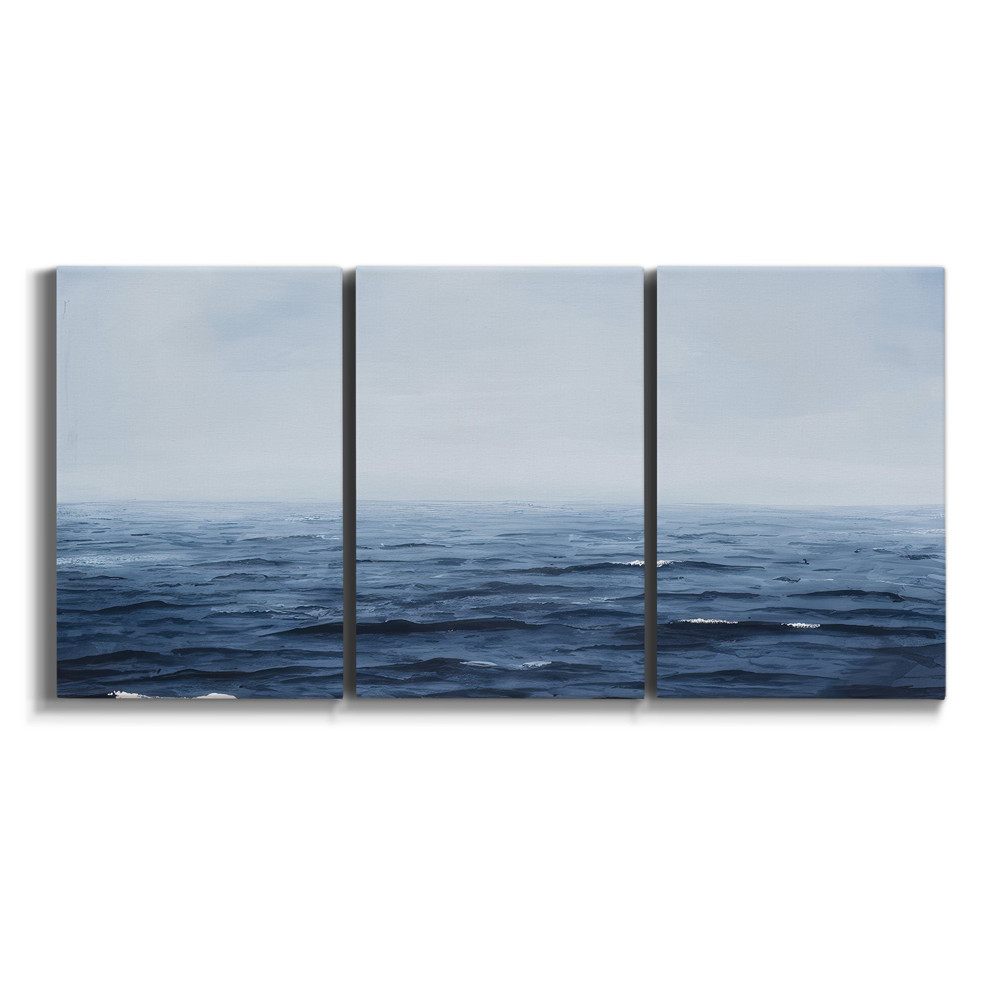 Three-panel canvas wall art featuring grayscale seascape with horizon on white background.