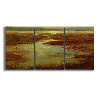 Three-panel canvas wall art featuring coastal shoreline with warm light on white background.