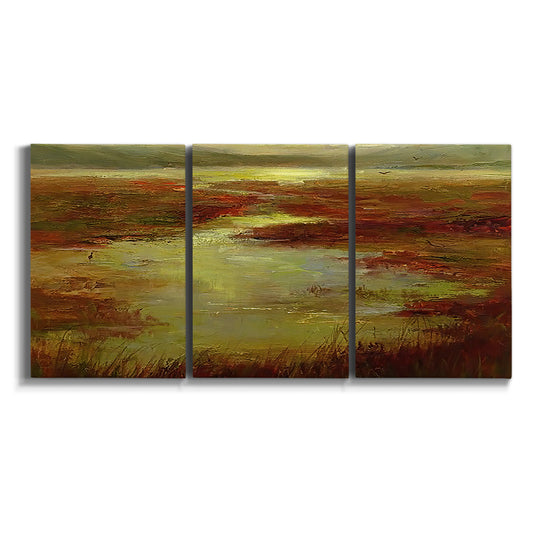 Three-panel canvas wall art featuring coastal shoreline with warm light on white background.