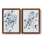 Set of two maple barnwood framed canvas prints featuring two expressive watercolor botanical paintings featuring loose blue flowers and leafy branches.