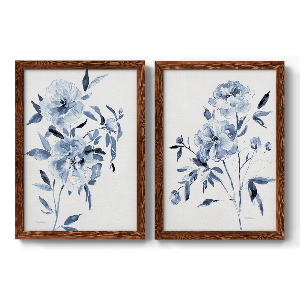 Set of two maple barnwood framed canvas prints featuring two expressive watercolor botanical paintings featuring loose blue flowers and leafy branches.
