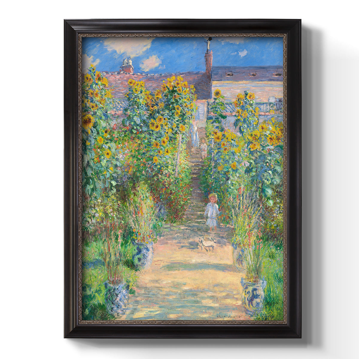 Impressionist garden landscape painting by Claude Monet printed on canvas in an ornate black frame with gilded inner detail with a vertical orientation.