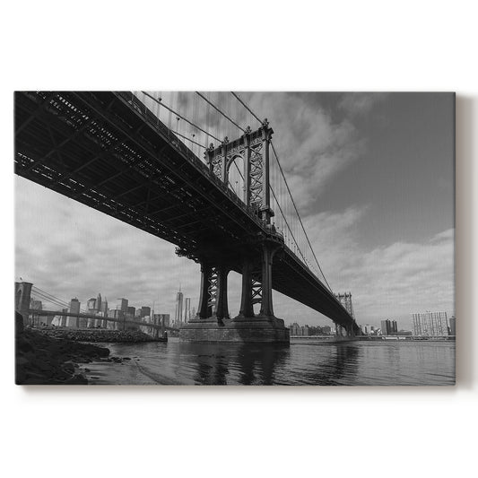 Manhattan Bridge spans across East River with skyline view on a cloudy day