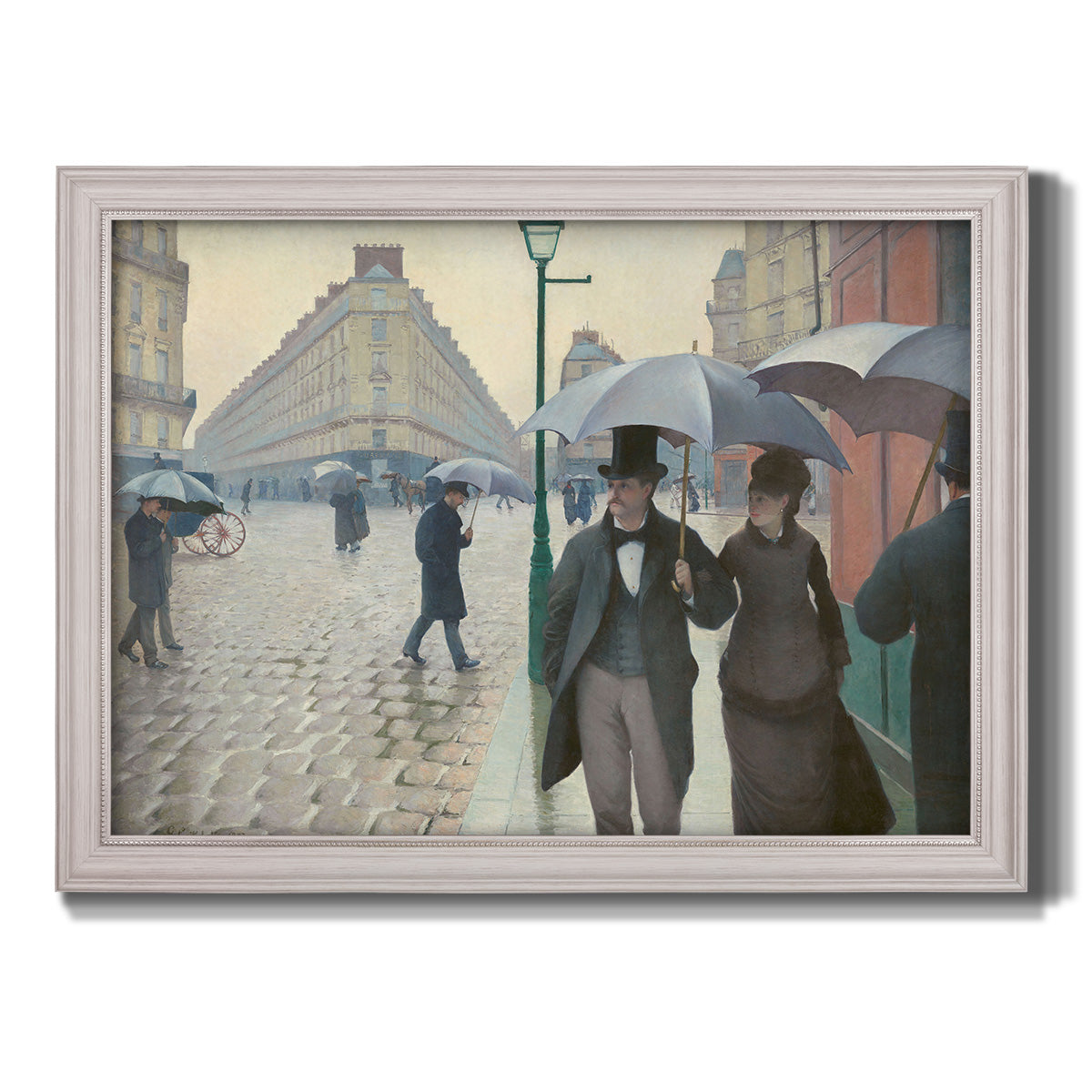 Impressionist urban street scene in the rain by Gustave Caillebotte printed on canvas in an ornate weathered white frame.