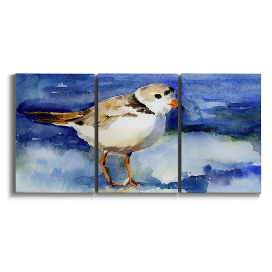 Three-panel canvas wall art featuring shorebirds standing in shallow water on white background.