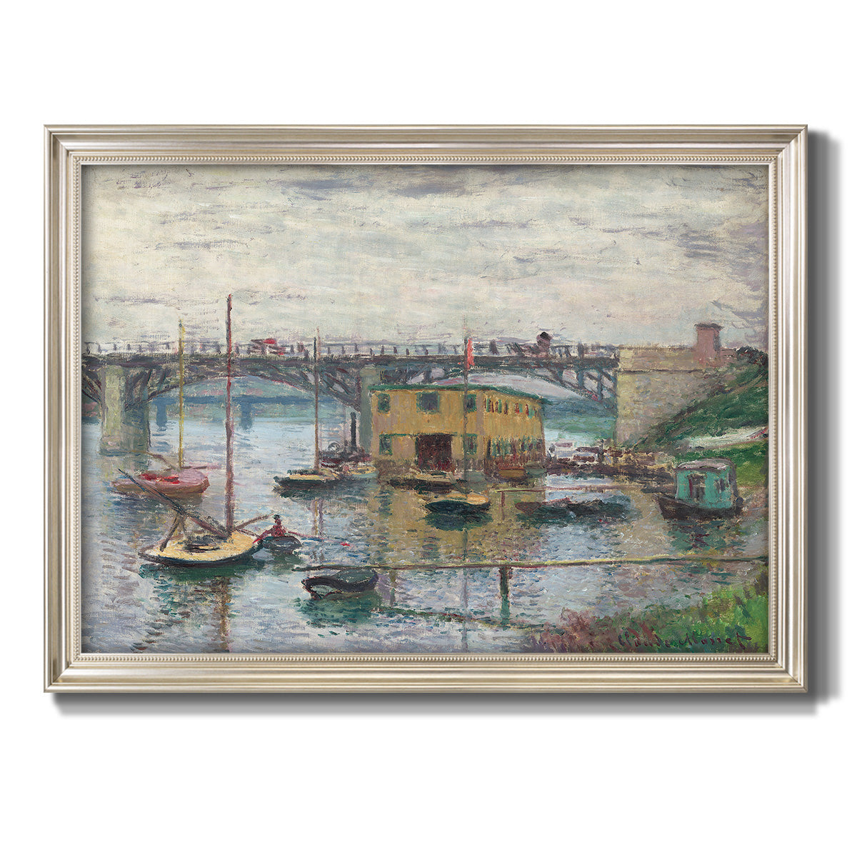 Impressionist river bridge scene on an overcast day by Claude Monet printed on canvas in an ornate champagne frame.