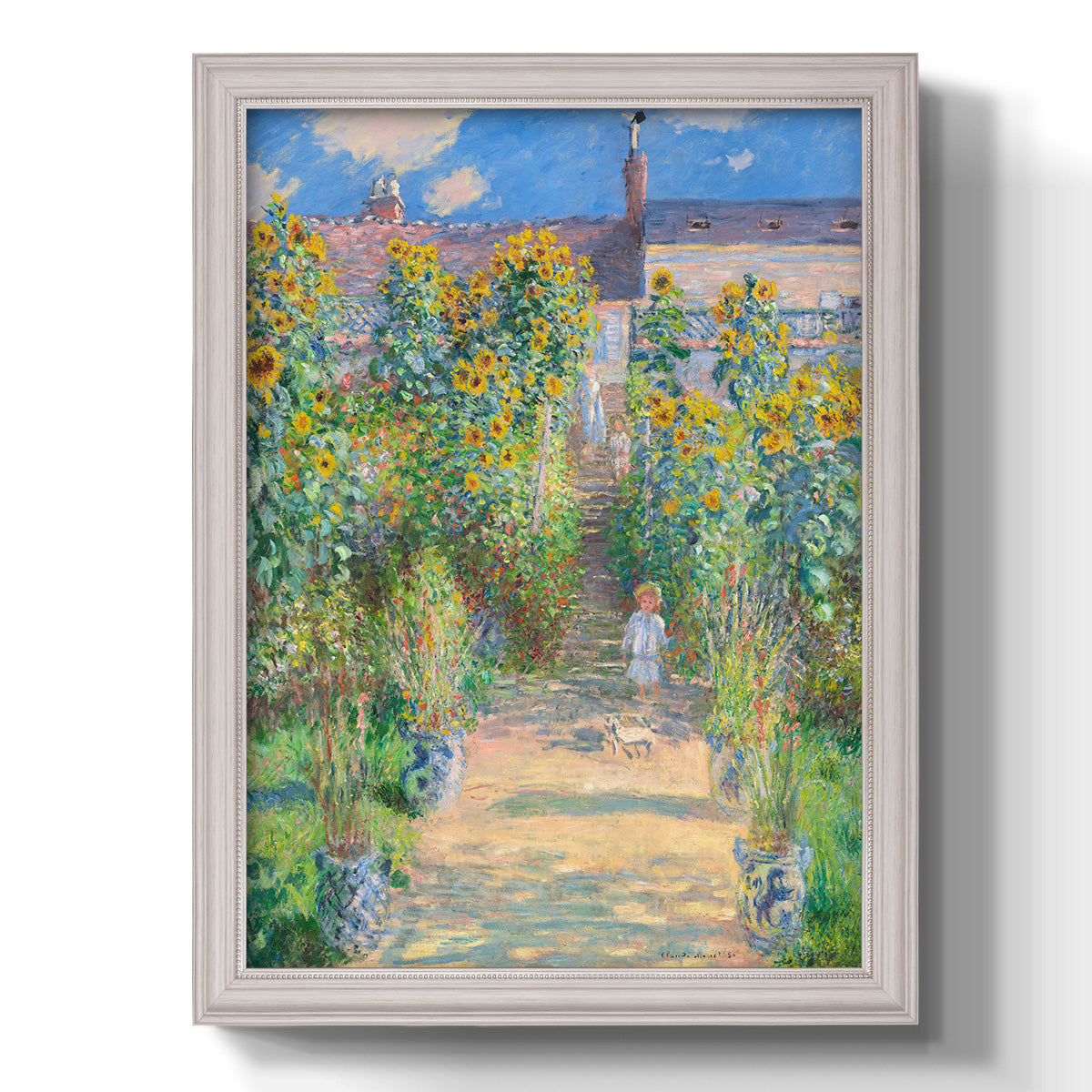 Impressionist garden landscape painting by Claude Monet printed on canvas in an ornate weathered white frame with a vertical orientation.