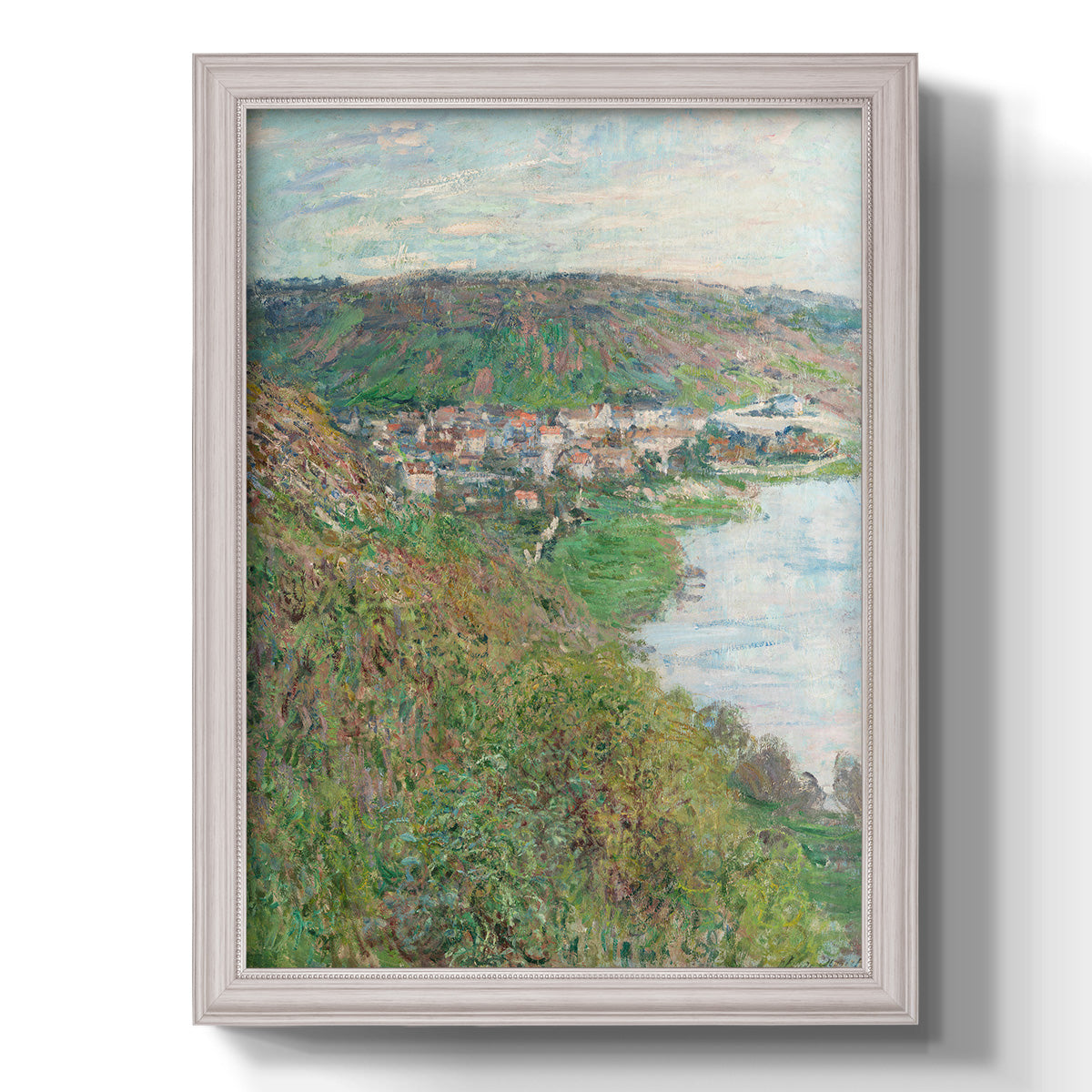 Impressionist landscape view of Vétheuil by Claude Monet printed on canvas in an ornate weathered white frame with a vertical orientation.