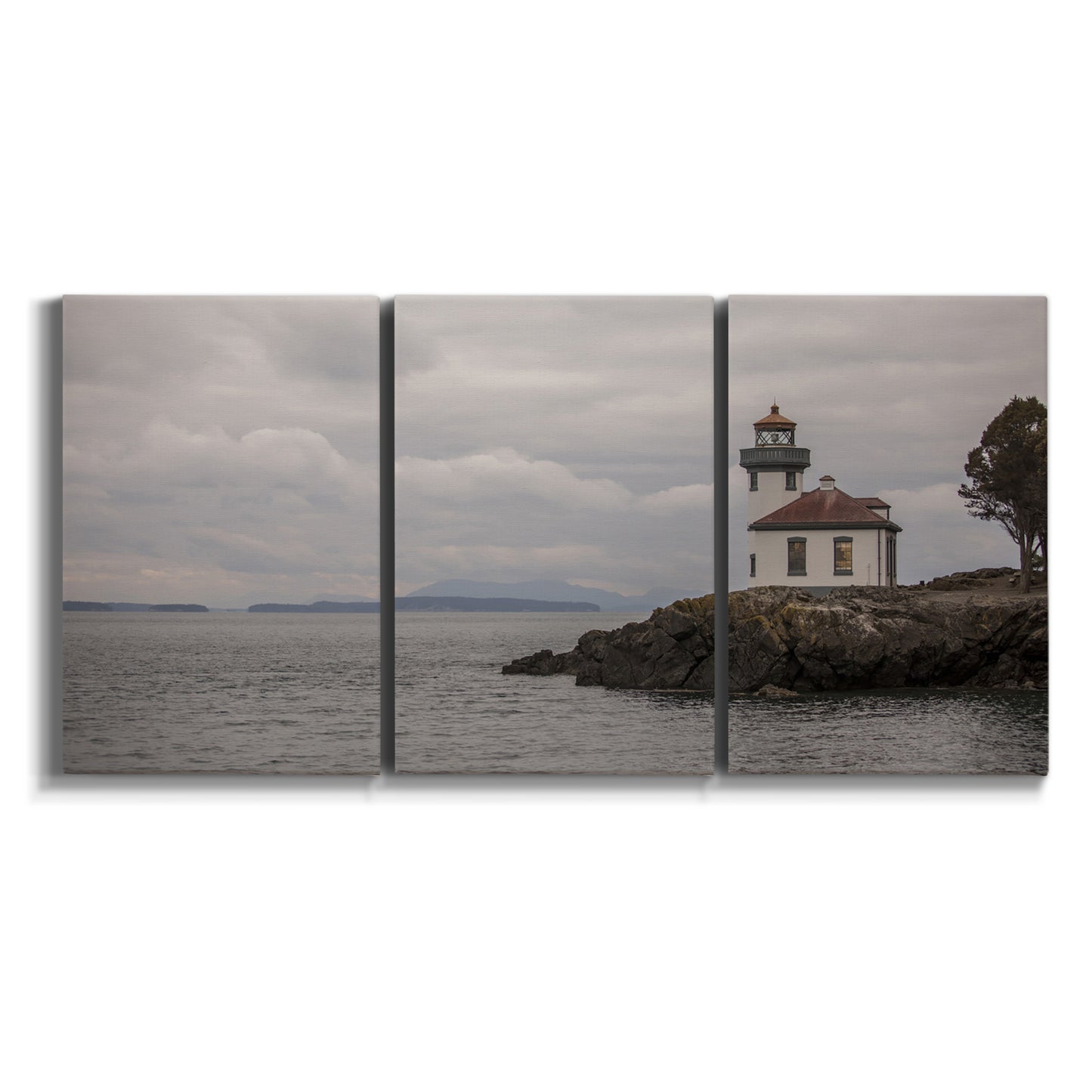 Three-panel canvas wall art featuring lighthouse watching over coastline on white background.