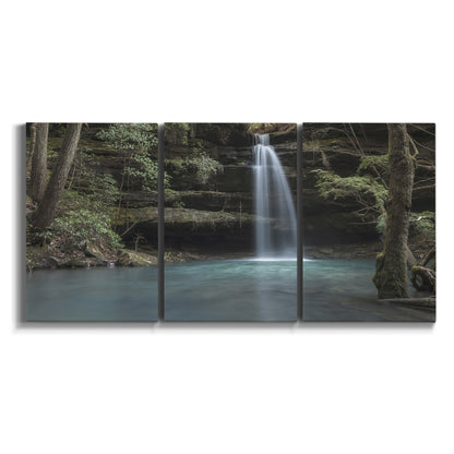 Three-panel canvas wall art featuring waterfall cascading through forest on white background.