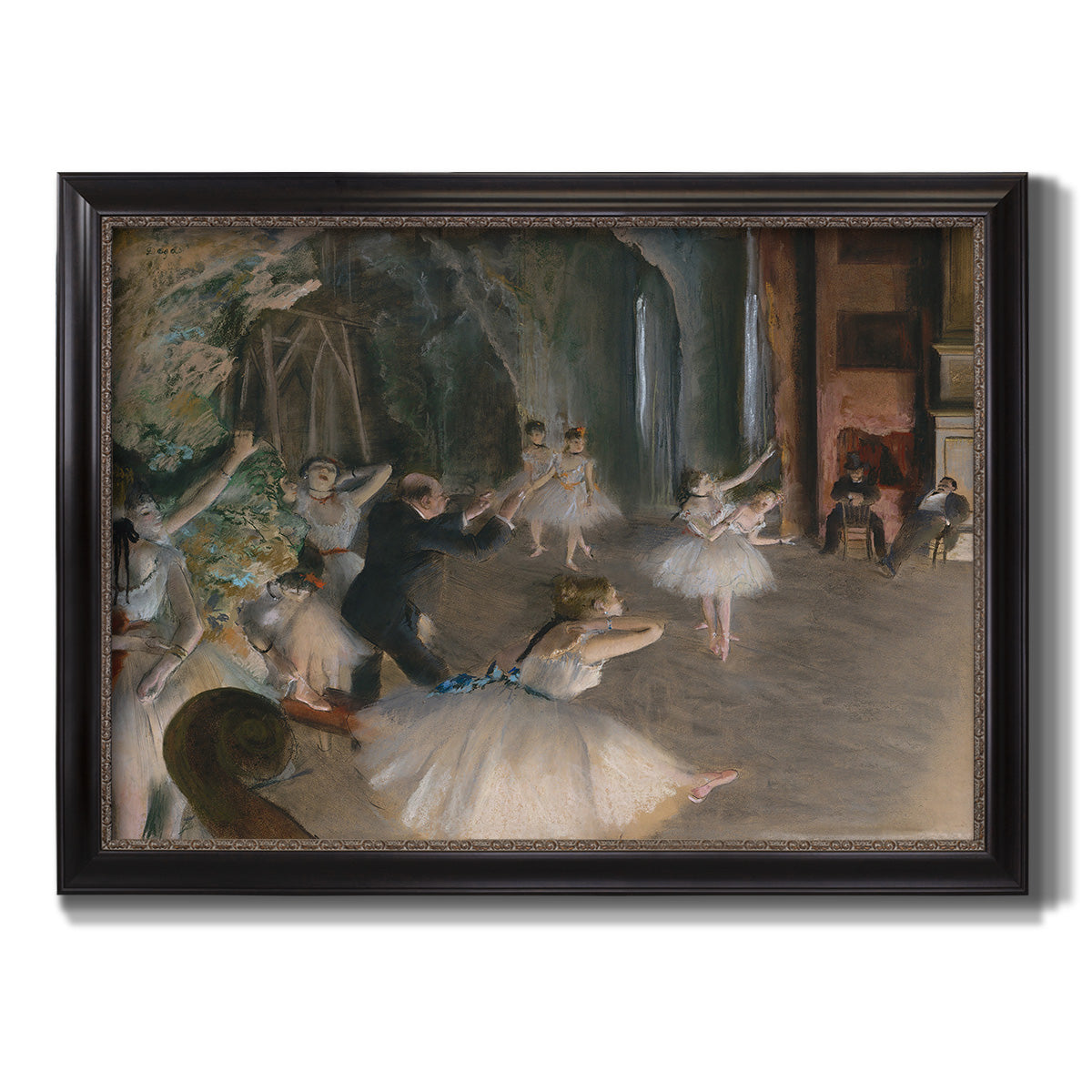 Impressionist backstage ballet scene by Edgar Degas printed on canvas in an ornate black frame with gilded inner detail.