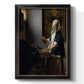 Quiet interior genre scene of a woman with scales by Johannes Vermeer printed on canvas in an ornate black frame with gilded inner detail with a vertical orientation.