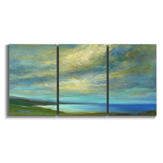 Three-panel canvas wall art featuring coastal shoreline with soft waves on white background.