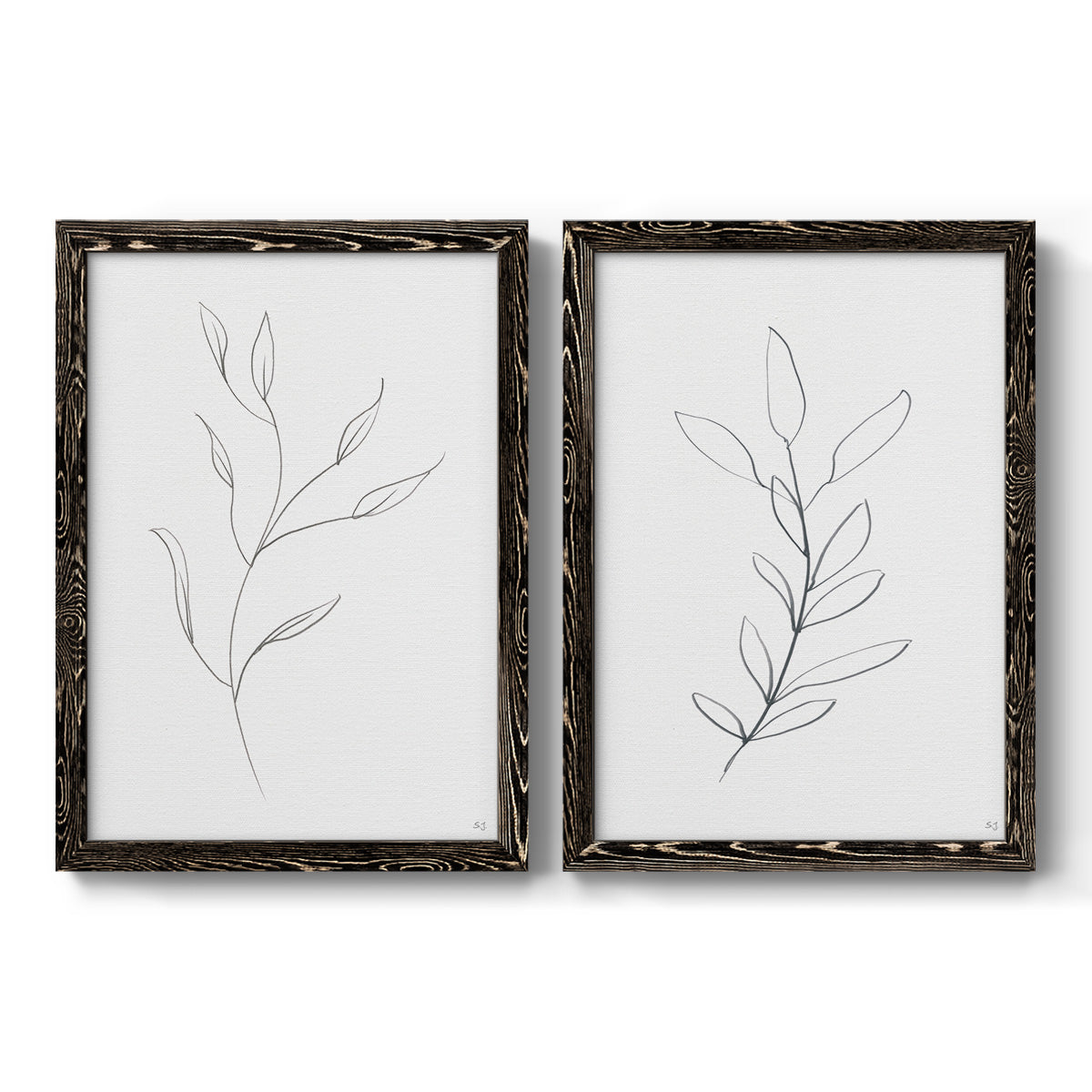 Set of two black barnwood framed canvas prints featuring two minimalist botanical line drawings featuring single continuous-line leafy branches.
