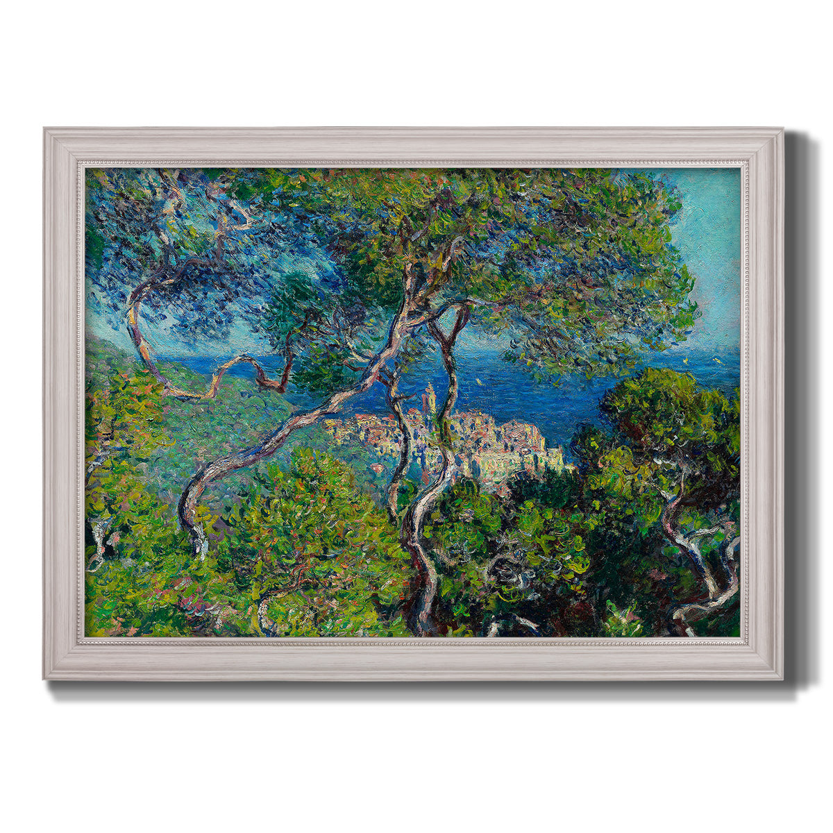 Impressionist Mediterranean coastal landscape by Claude Monet printed on canvas in an ornate weathered white frame.