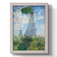 Impressionist portrait of a woman with a parasol by Claude Monet printed on canvas in an ornate weathered white frame with a vertical orientation.