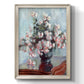 Impressionist chrysanthemum floral painting by Claude Monet printed on canvas in an ornate black frame with gilded inner detail with a vertical orientation.