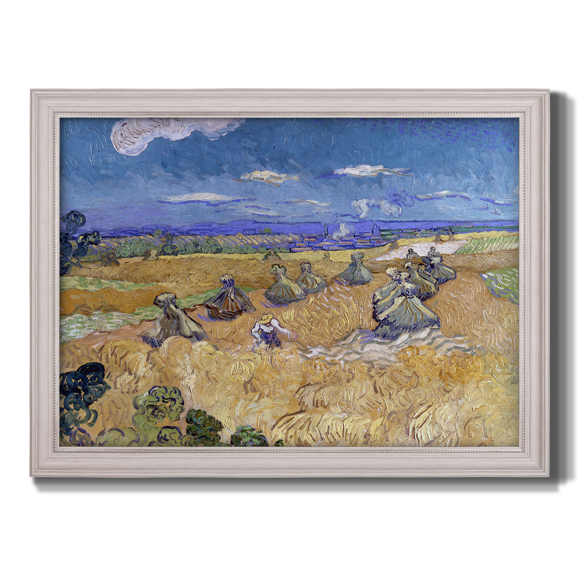 Impressionist wheat harvest scene by Vincent van Gogh printed on canvas in an ornate weathered white frame.