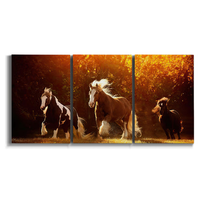Three-panel canvas wall art featuring running horses across open field on white background.