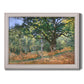 Impressionist forest landscape at Fontainebleau by Claude Monet printed on canvas in an ornate weathered white frame.