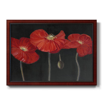 Modern red poppy floral artwork printed on canvas in an ornate cherry burl wood frame.
