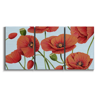 Three-panel canvas wall art featuring red poppies in motion on white background.