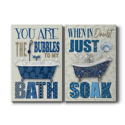 Set of two vertical canvas prints featuring playful bathroom typography artwork in blue tones, displayed side by side.